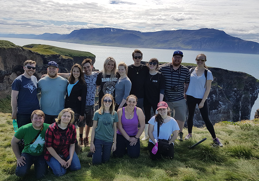 Group posing on top of Drangey Island